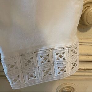 Chicos ankle length white pull on pants. Row of embroidery on the bottom.